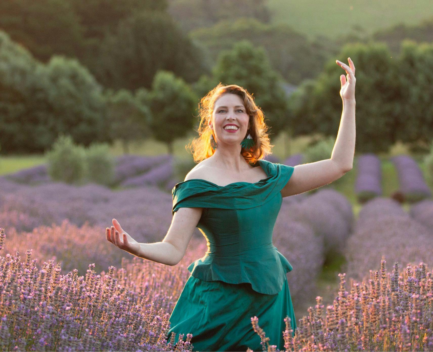 Katrina Waters poses in an evening gown in the middle of a lavender field
