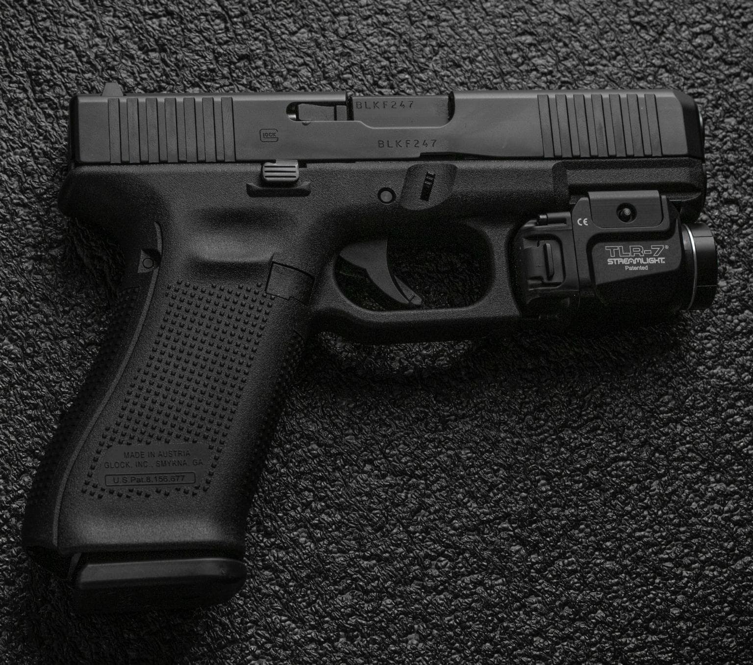 Black glock gun pictured on a black background