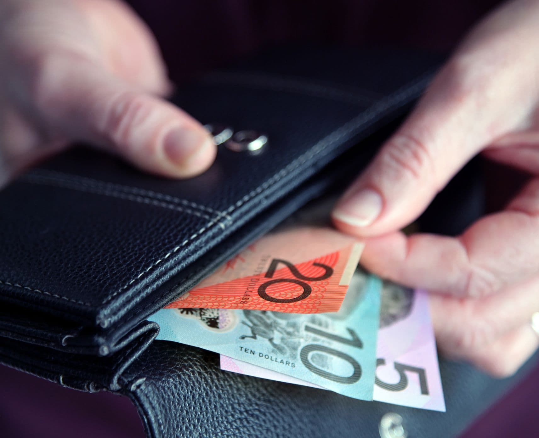 Person taking cash from their wallet