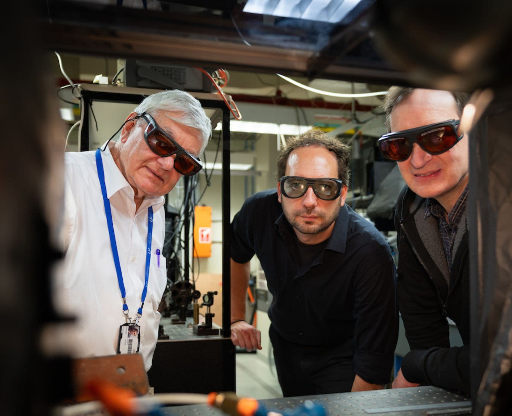 Three physicists in laser goggles