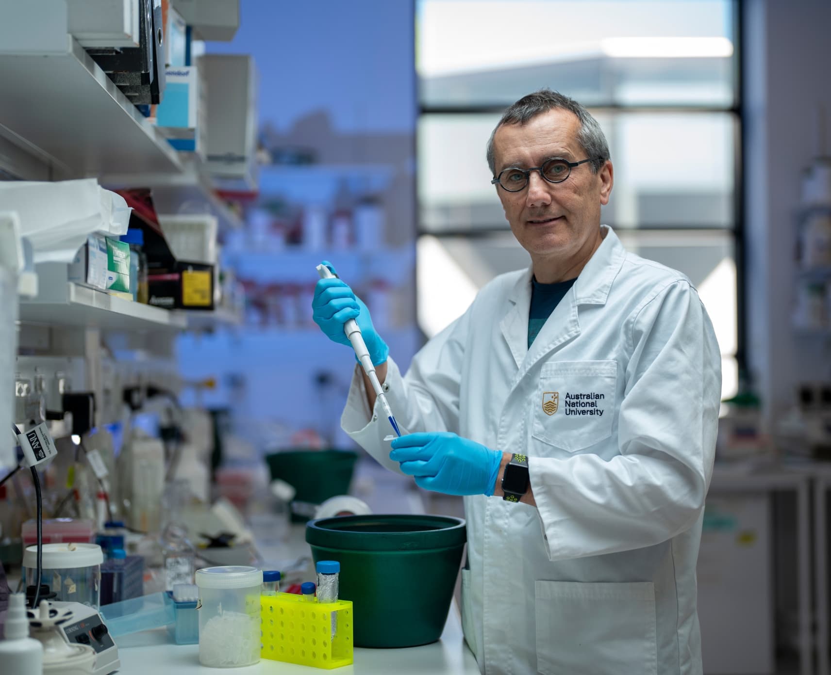 Professor Thomas Preiss in a lab environment. He is wearing a white lab coat