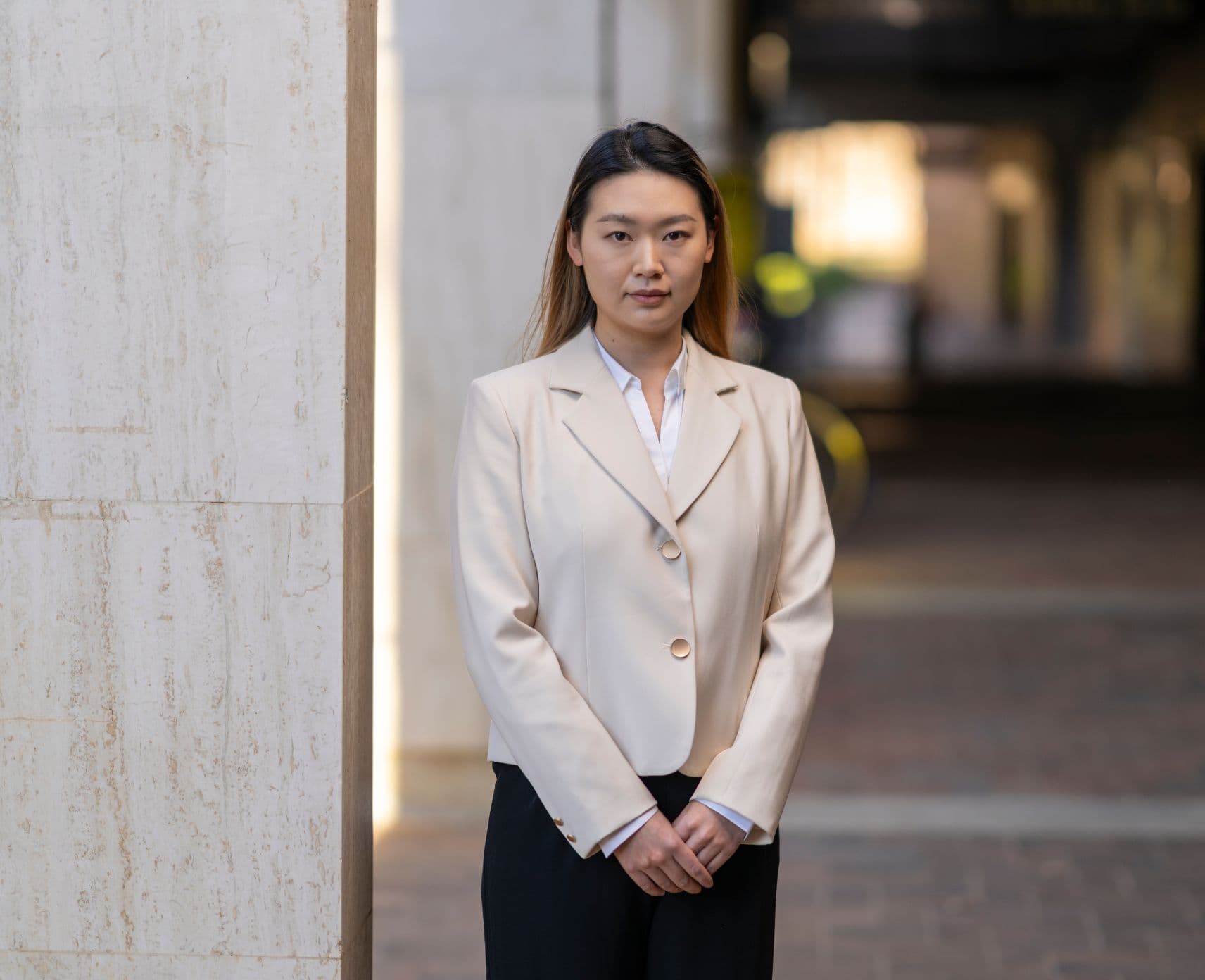 A young woman standing on campus.