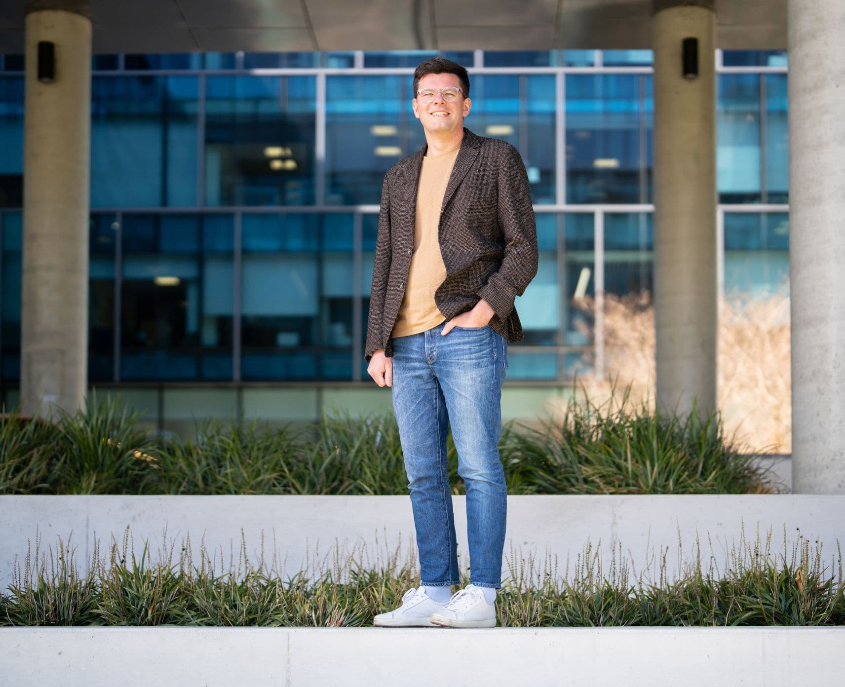 ANU professor standing outside a building at the ANU campus.