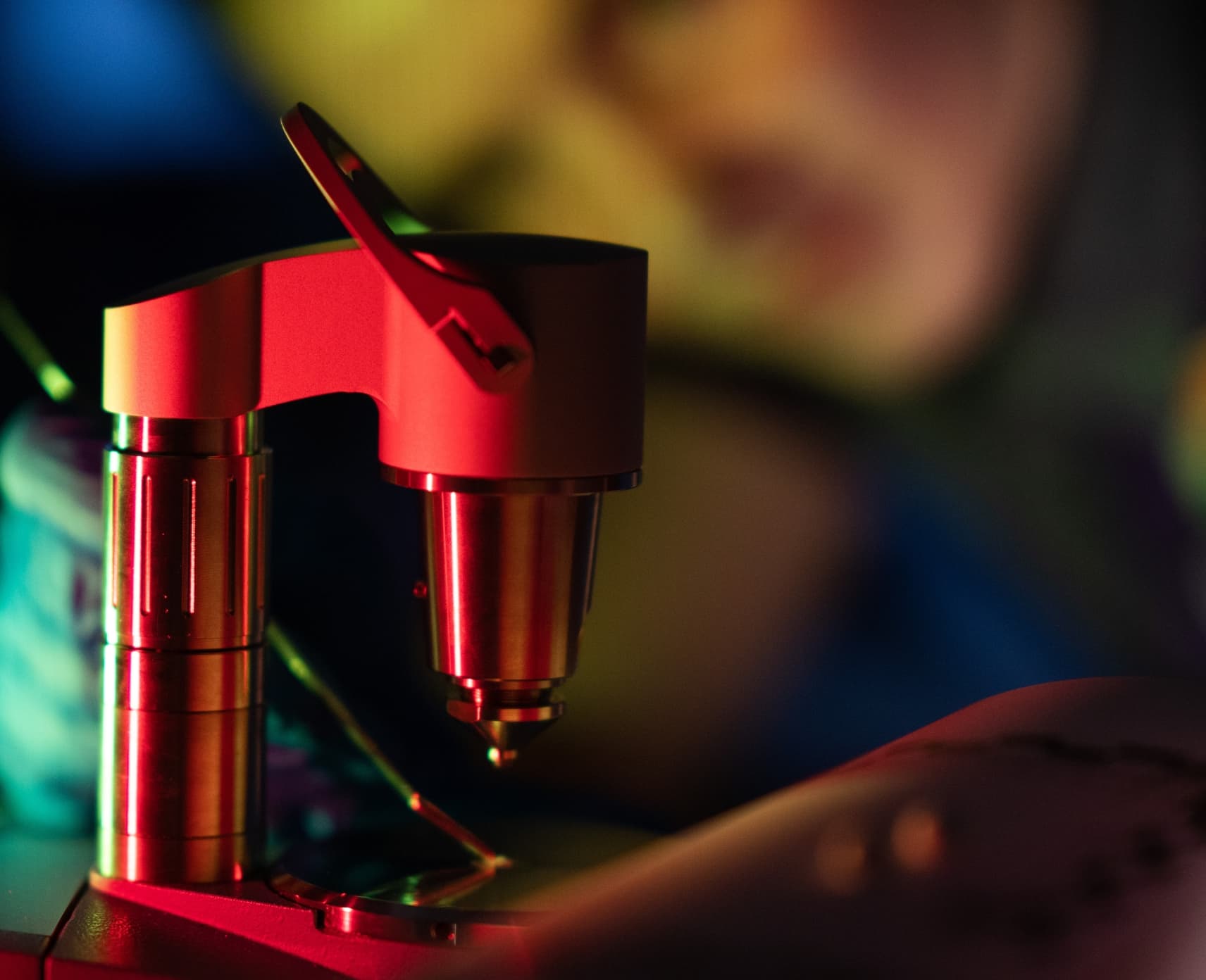 Chemical Analyst and ANU PHD candidate Cassidy Whitefield is blurred in the background with a spectrometer at CanTEST Health and Drug Checking Service highlighted in red in the foreground.