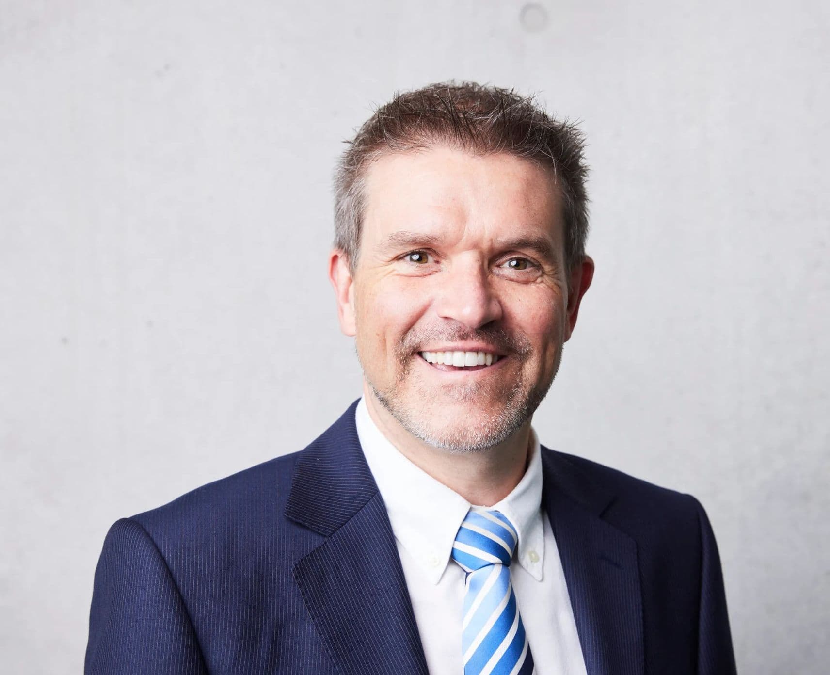 Man smiles at camera.