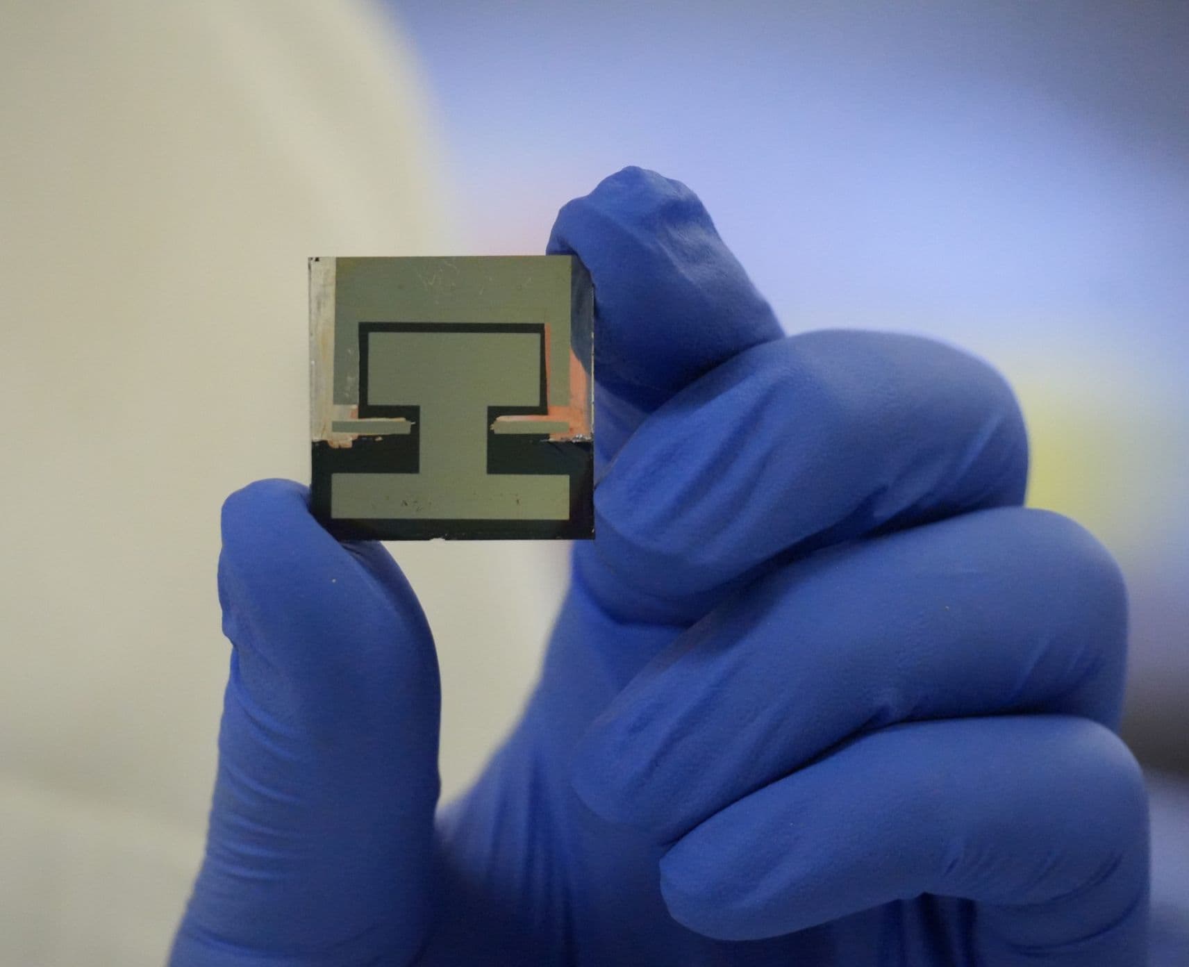 A small perovskite solar cell being held by a person.