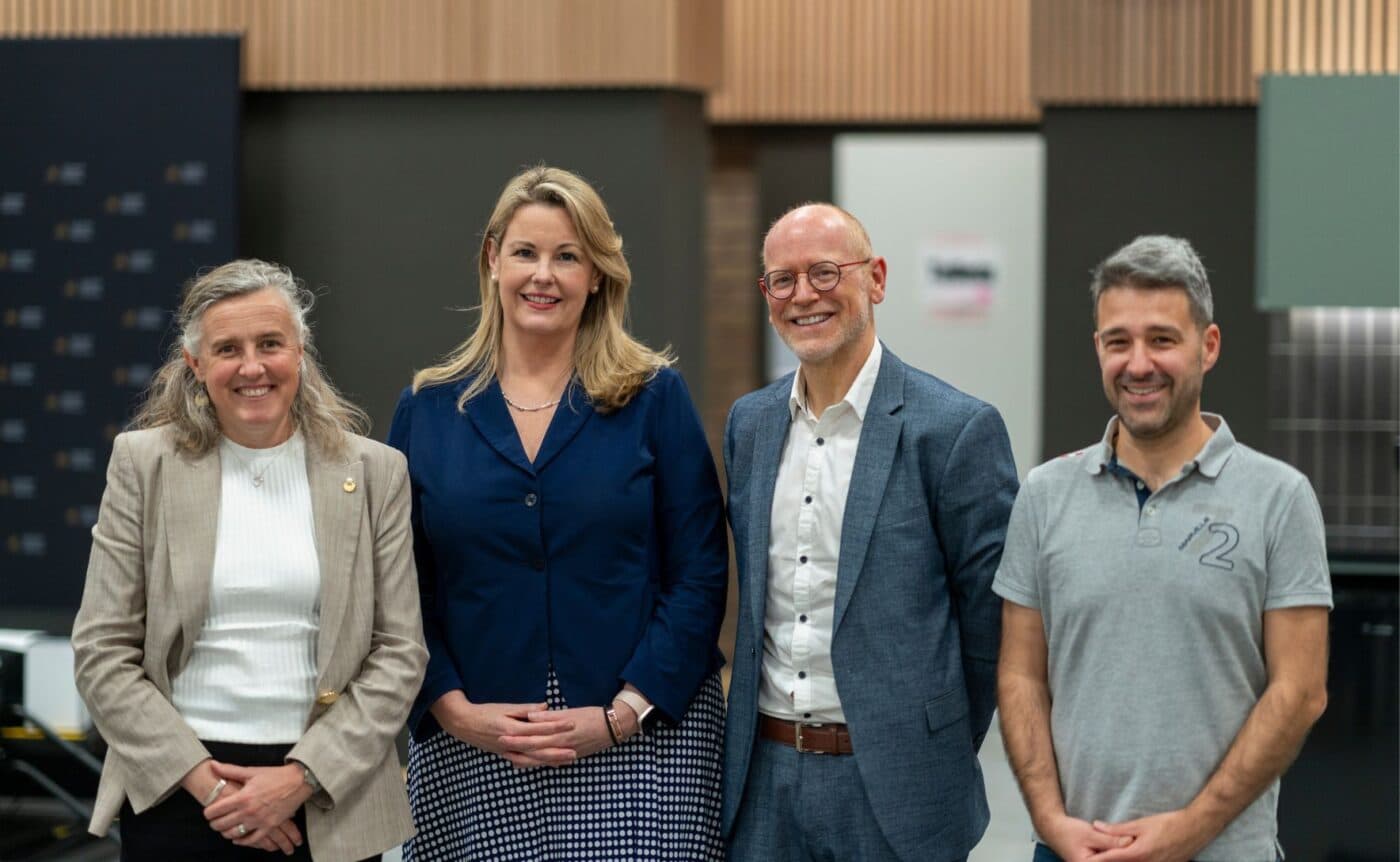 Four people at an event pose for the camera