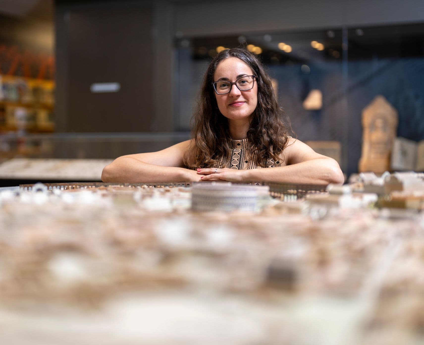 Researcher with a model of ancient Greek buildings