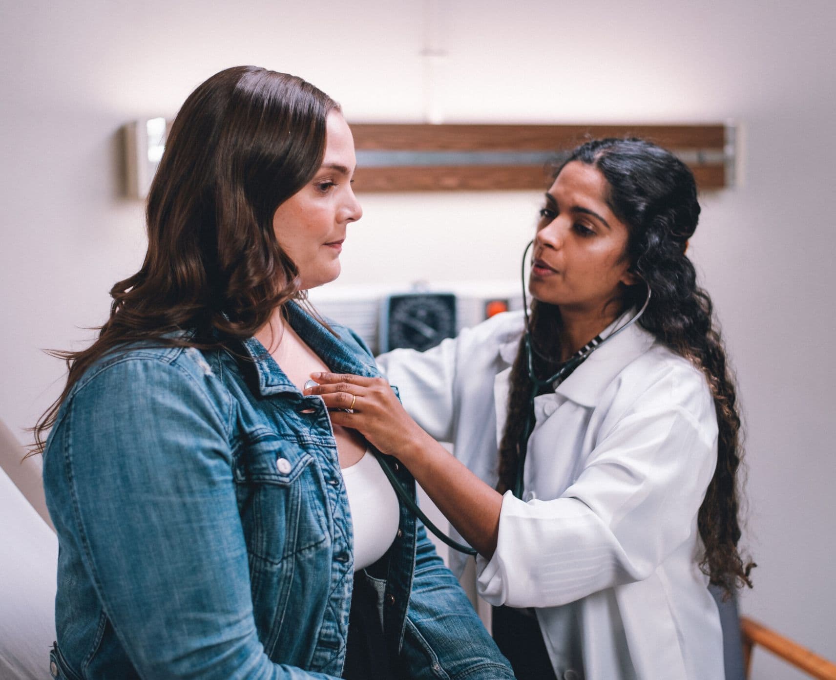 patient at a helath appointment with medical professional checking heart rate