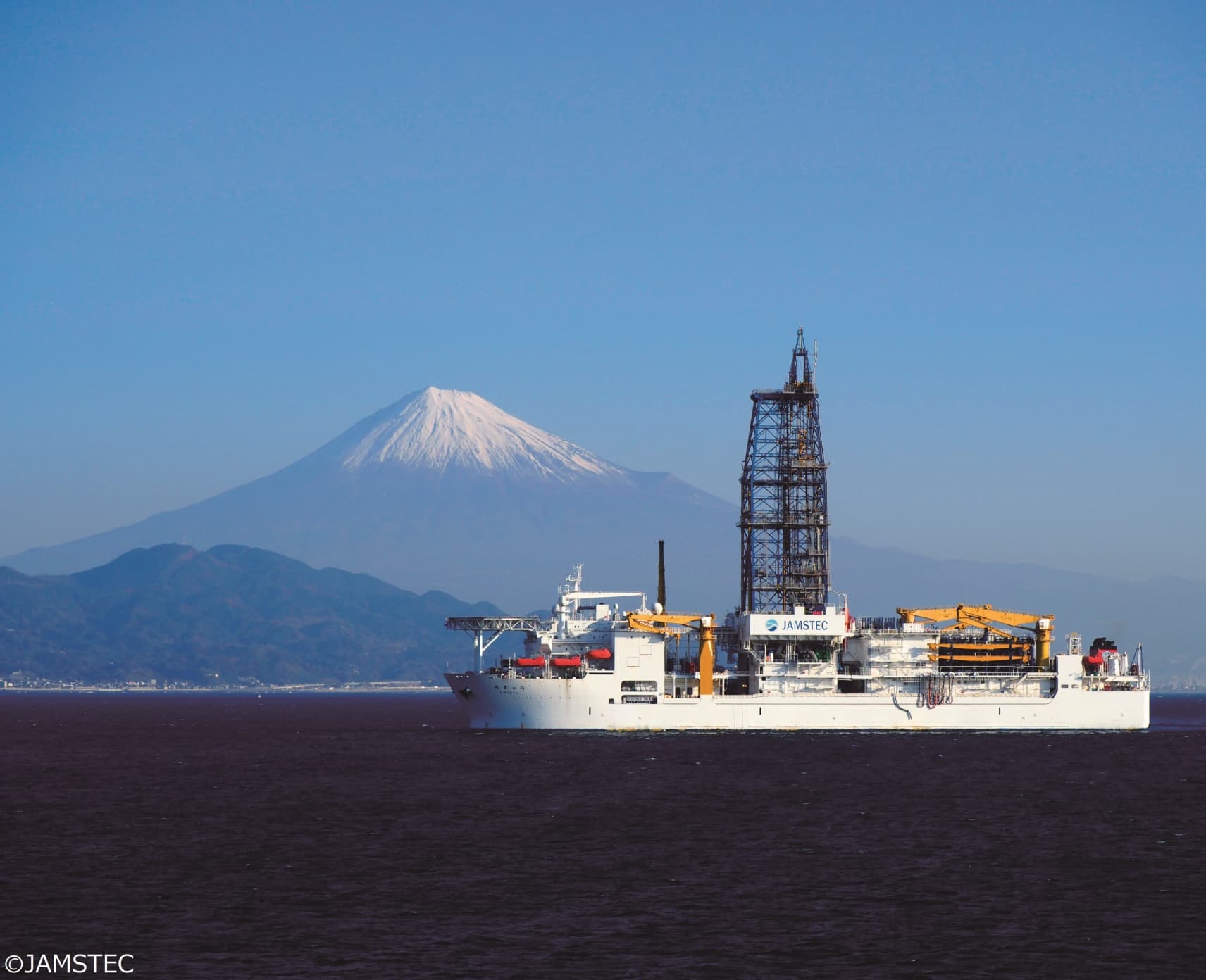 The world’s most advanced drilling-equipped science vessel, Chikyu sailing in the ocean with Mount Fuji in the background.