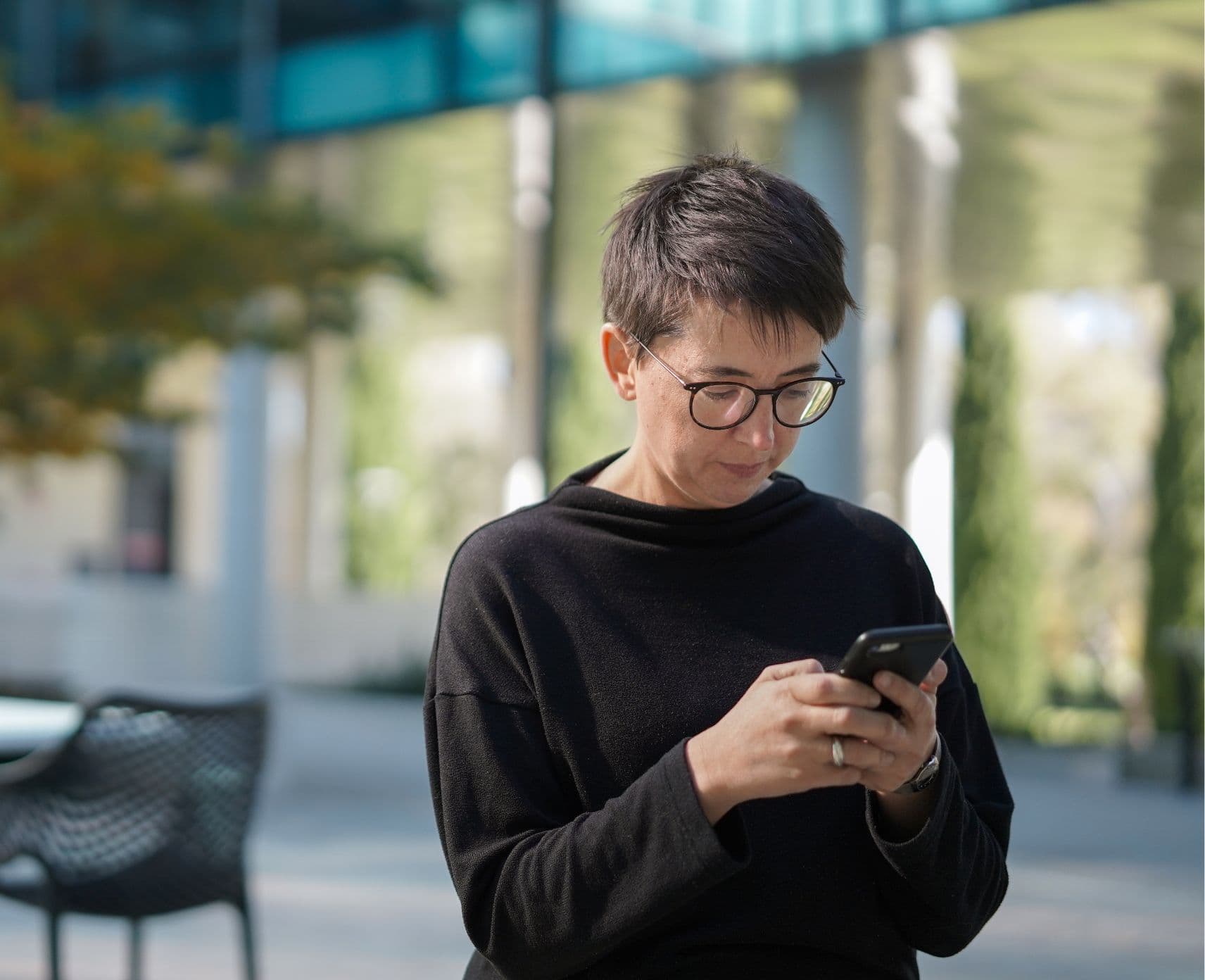 headshot of researcher looking at phone