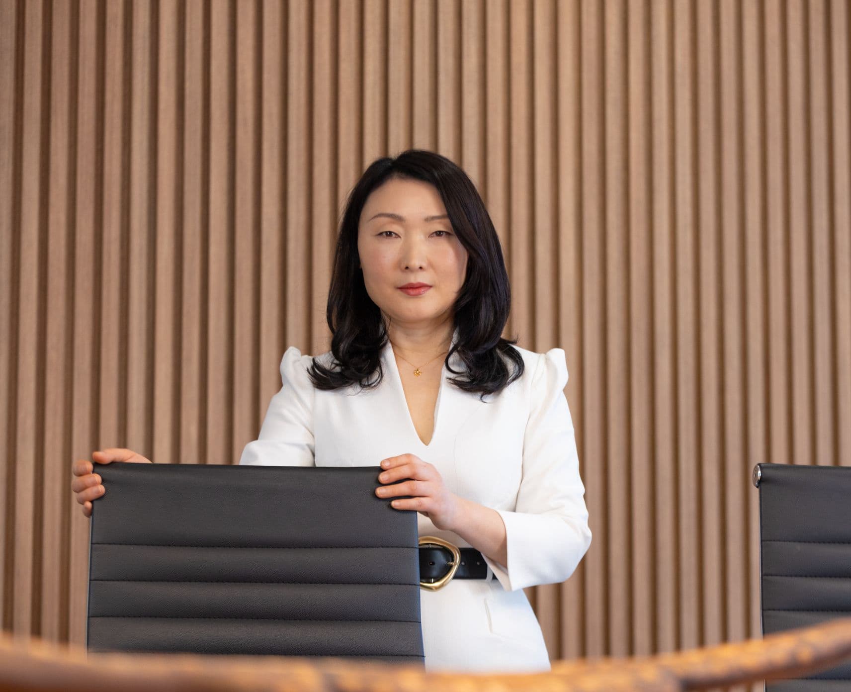 A woman hold a seat in a board room