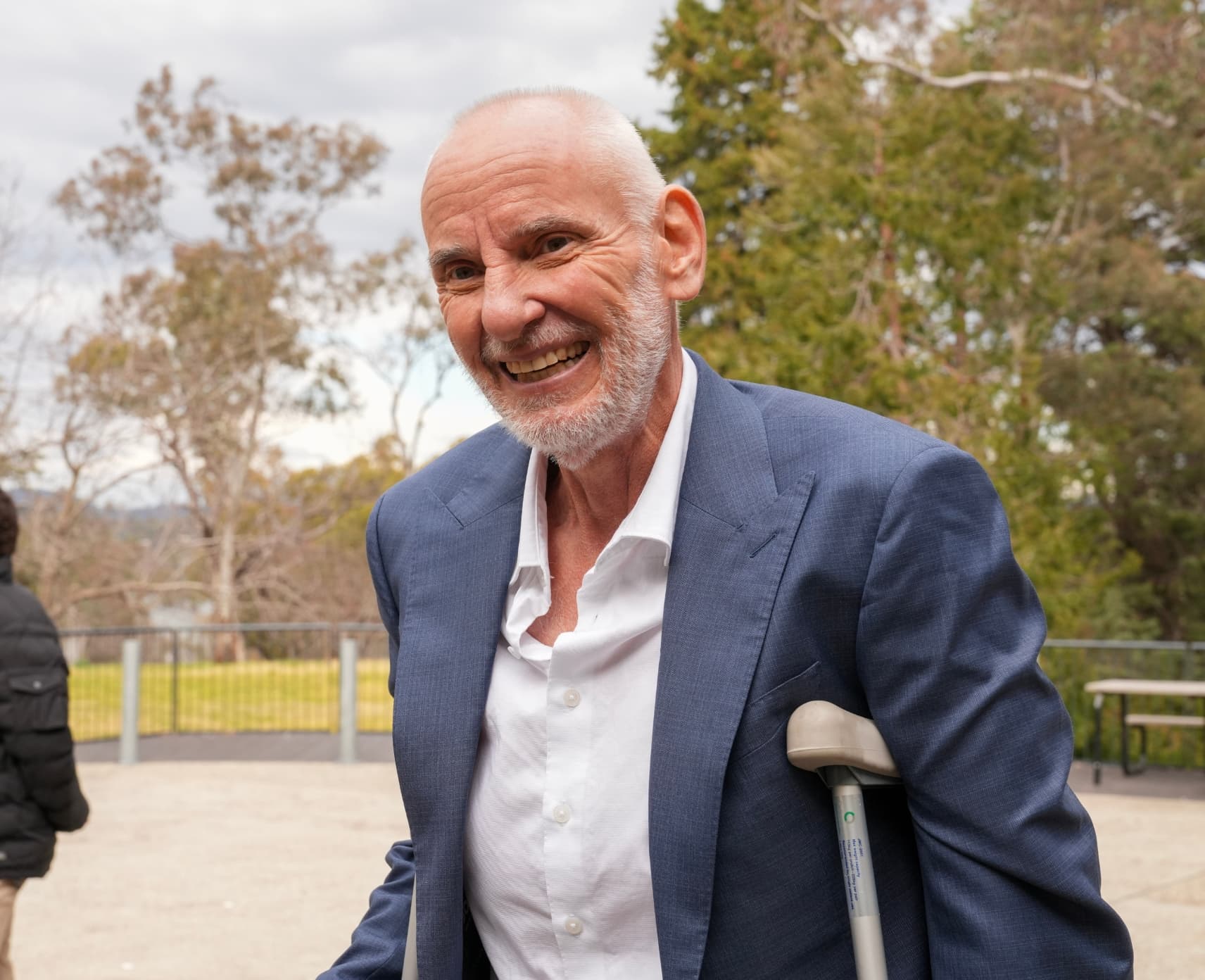 Man on crutches smiling