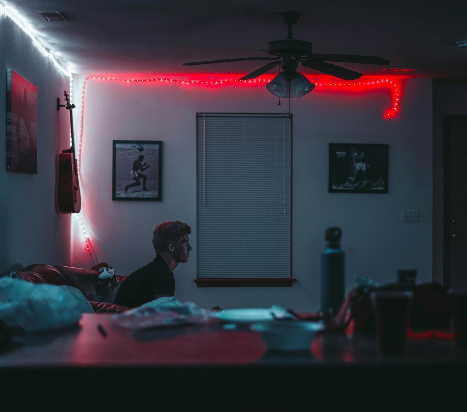 man sitting in a dark room alone