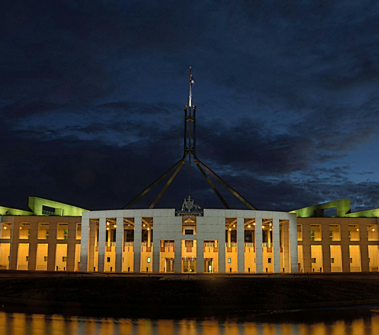 Parliament house lit up at night time.