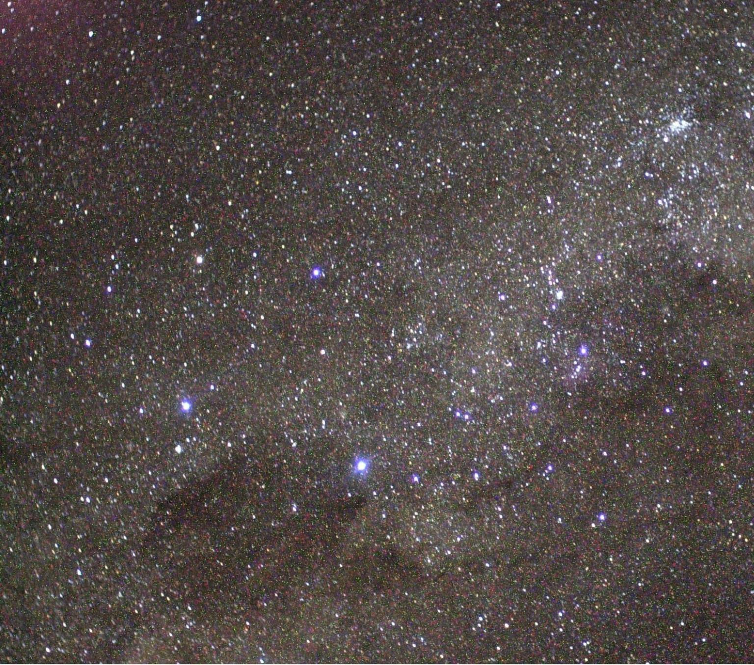 The Southern Cross (left center), the Coal Sack Nebula (bottom left), and the Carina Nebula (upper right) are visible in this view