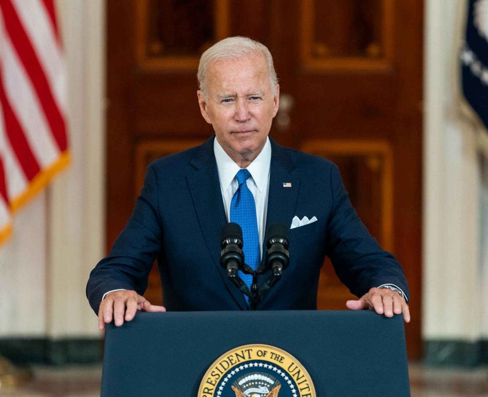 President Joe Biden standing presenting a speech