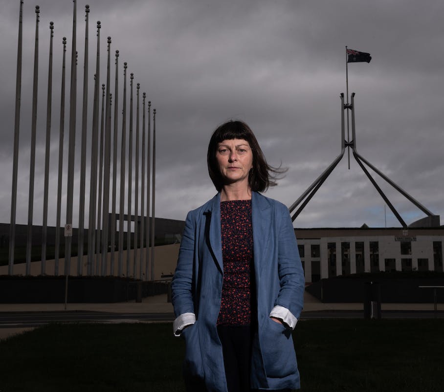 Professor Sharon Friel standing in front of Parliament House.