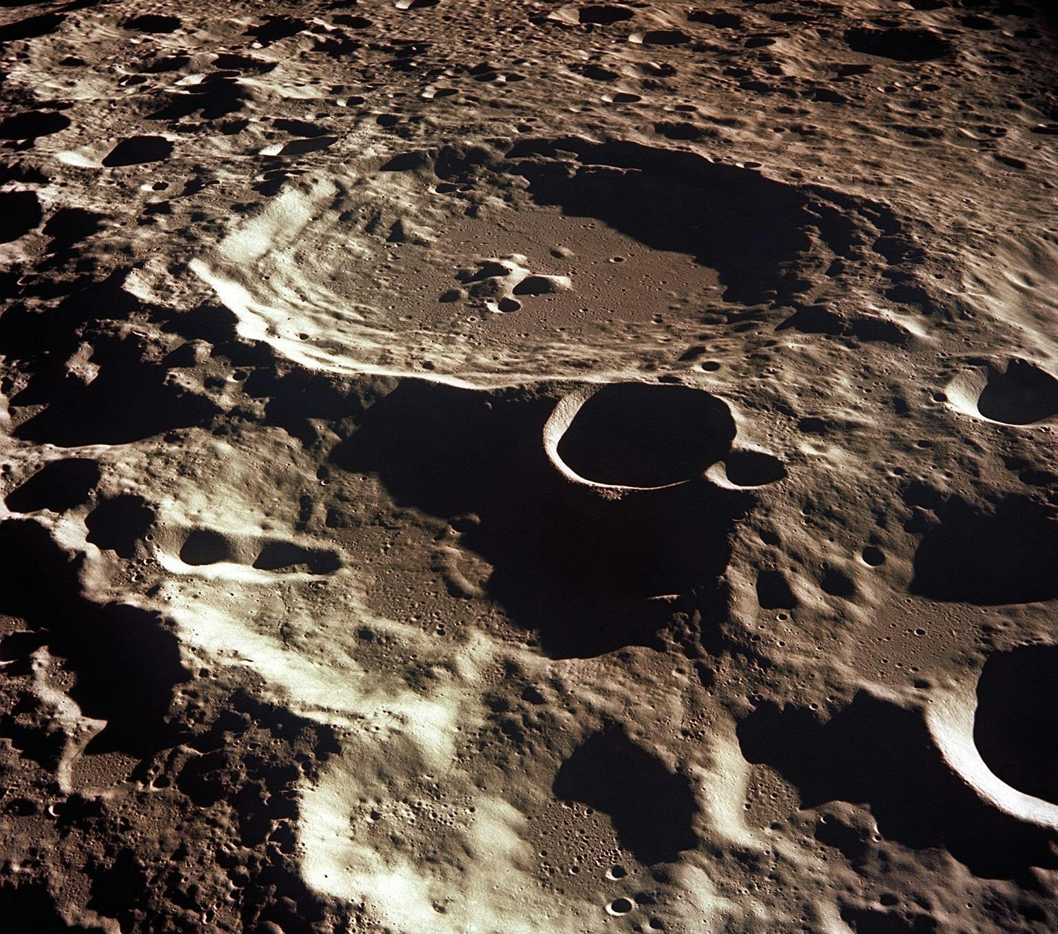 distinct and large craters on the moon, as seen from the Apollo 11 spacecraft