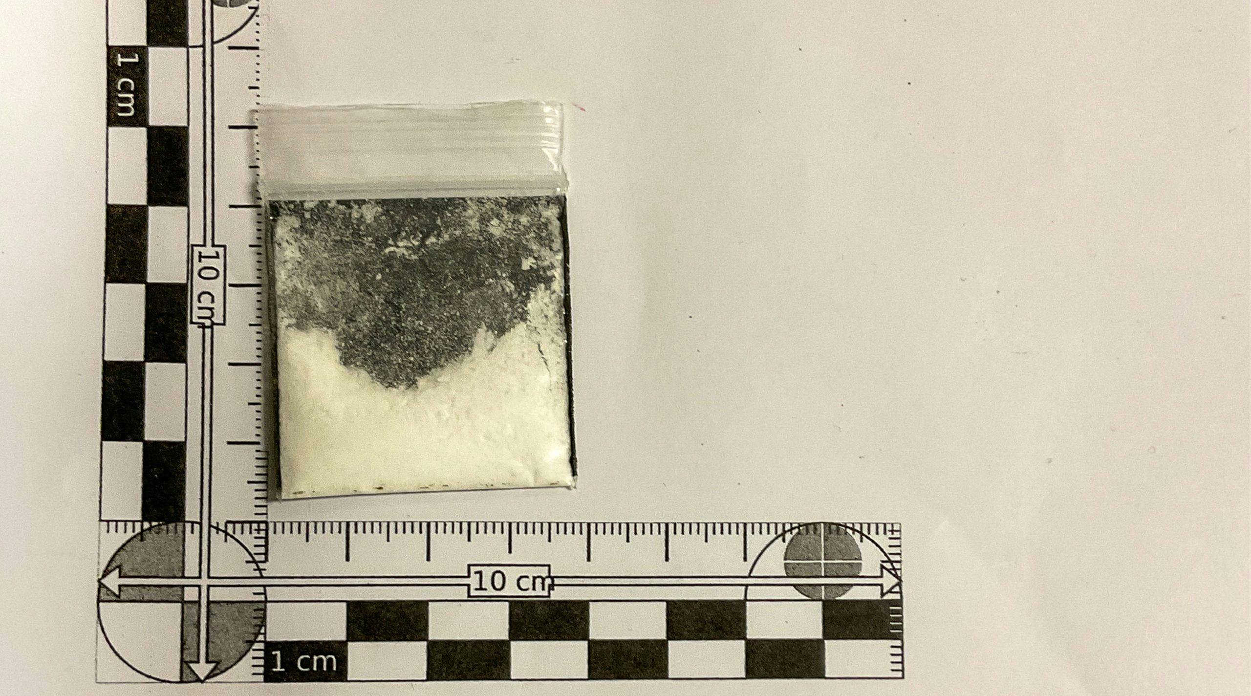 White powder in a small clear bag against a 10cm ruler
