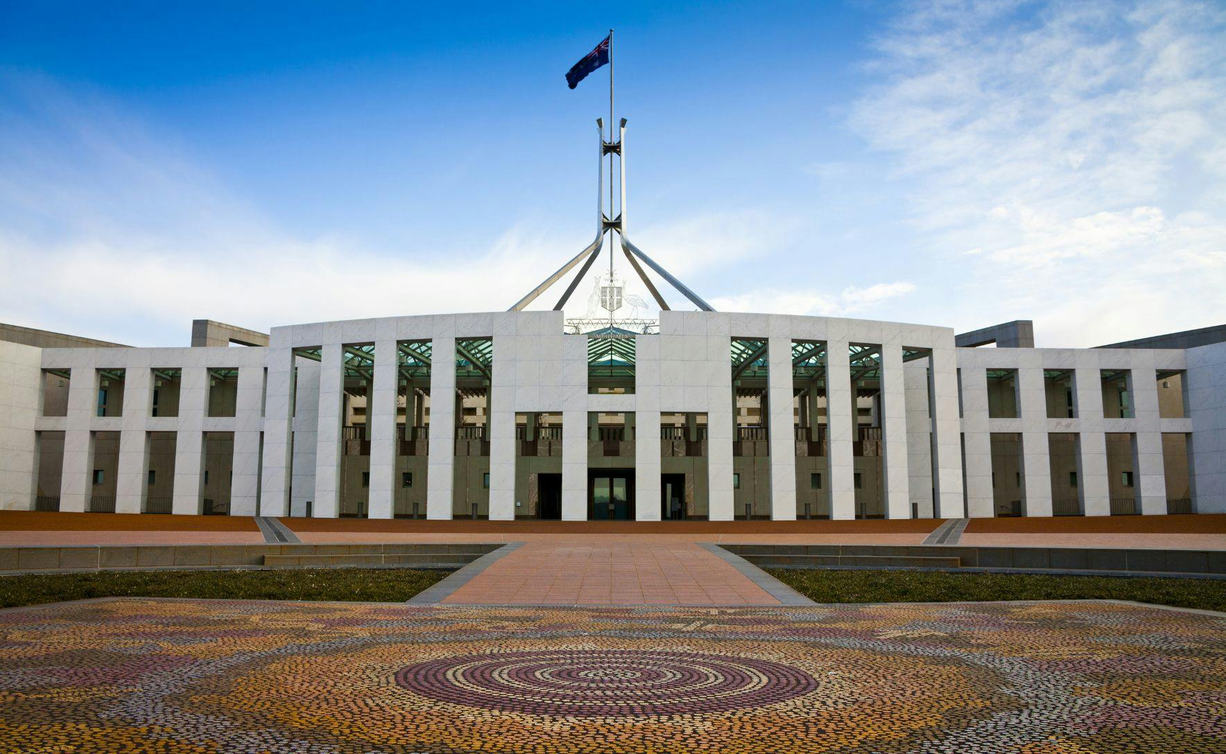 Parliament House with a mosaic on the forecourt.