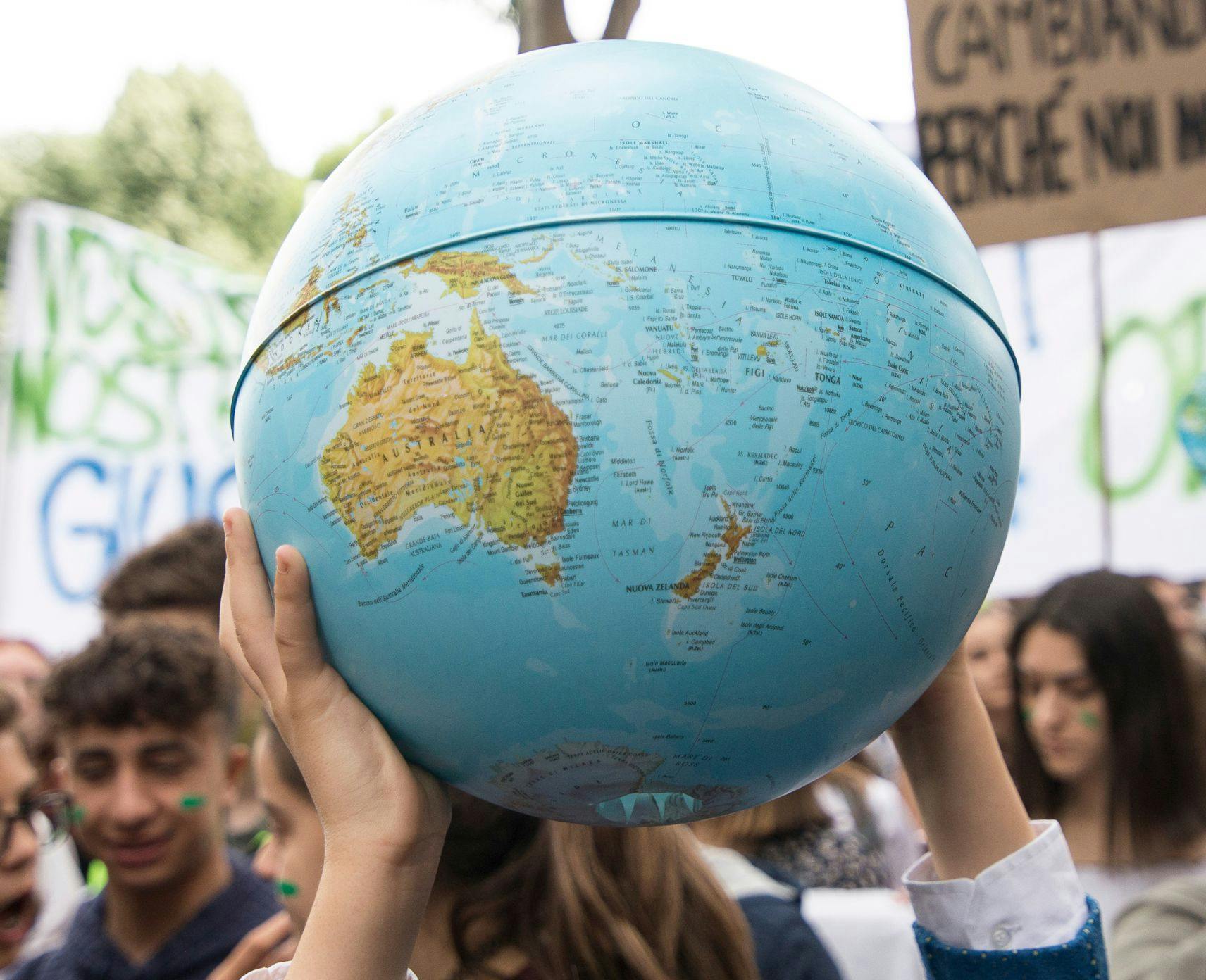 Globe showing Australia and the Pacific at a climate protest