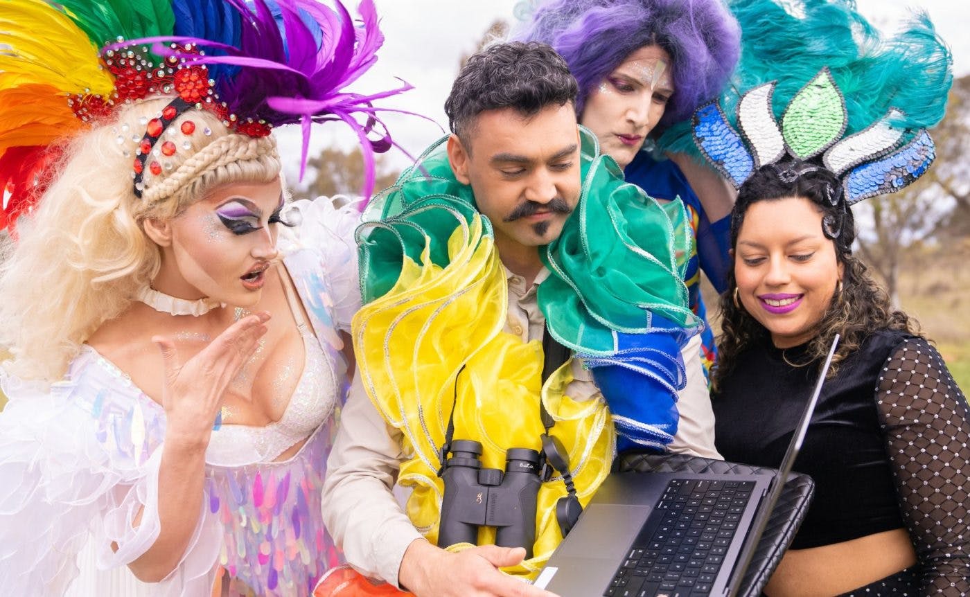 A combination of drag queens, ballet dancers and Brazilian funk dancers wearing colourful costumers filled to the brim with sequins. They are all dancing in a field in regional Victoria.